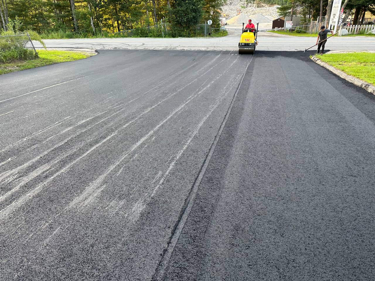 Asphalt resurfacing with rollers finishing an overlay